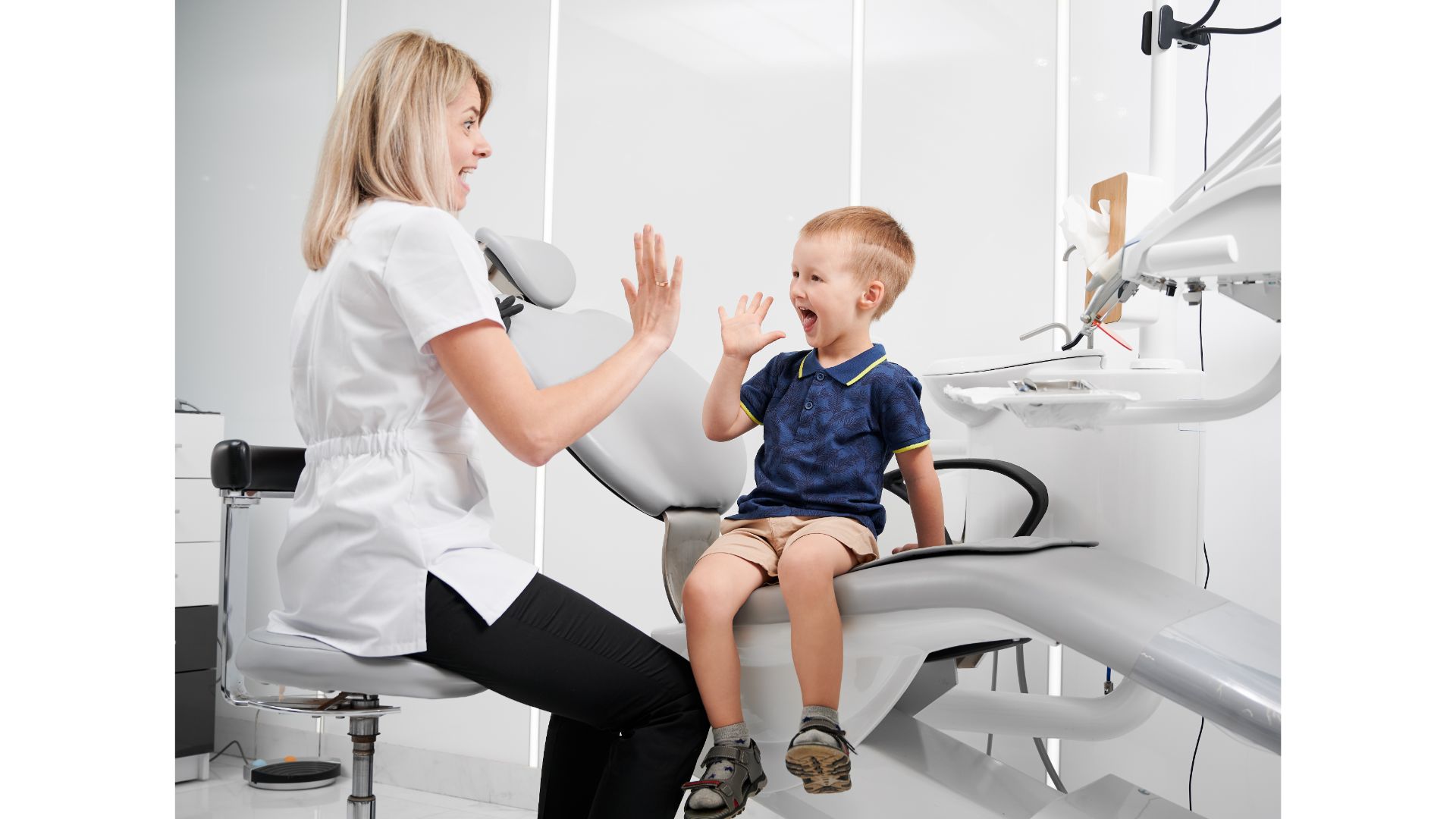 March 2024 Blog.  A dentist high-fiving a young boy.